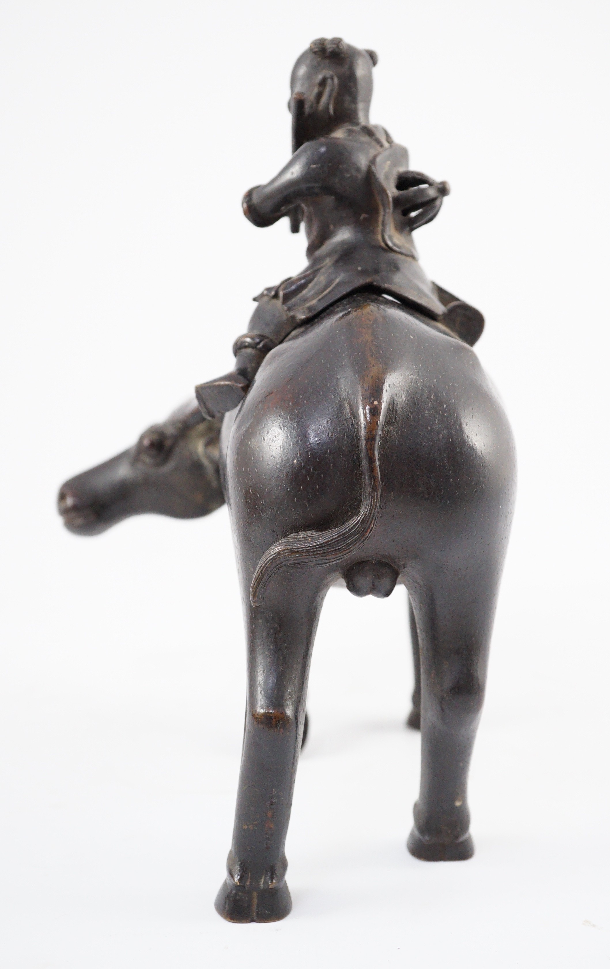 A Chinese bronze ‘boy riding a water buffalo’ censer, 17th/18th century, 22.5cm long, one horn detached but present